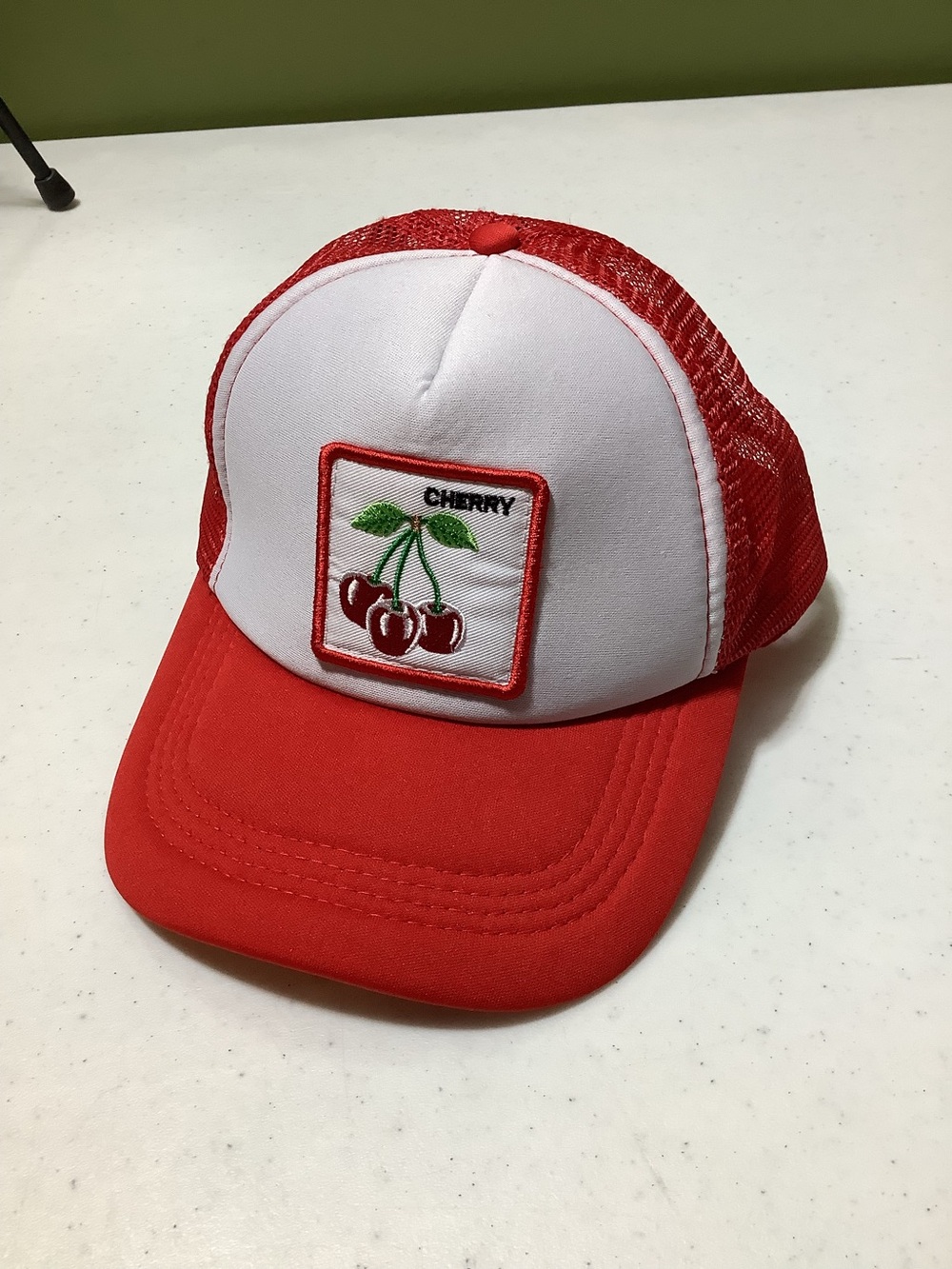 Red and white cherry trucker hat